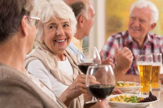 residents eating and drinking wine