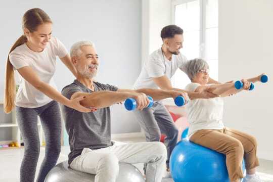 seniors lifting weights on exercise balls